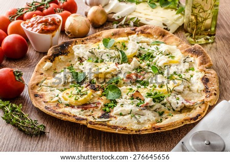 Pizza Bianco with Rosemary and Pancetta, with potatoes and creame cheese with garlic, sprinkled herbs and tomato