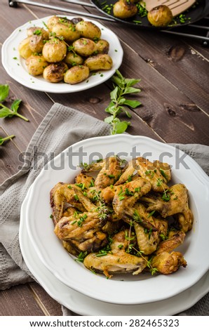 Roasted chicken wings with new potato - potato roasted in country  style