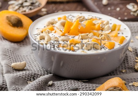 Domestic apricots musli yogurt with milk and crispy nuts and healthy seeds chia