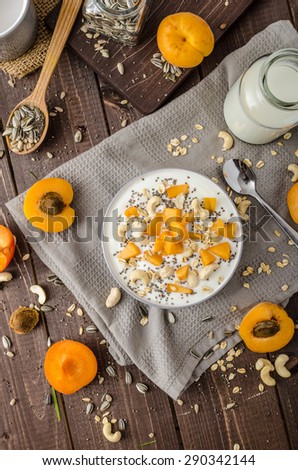 Domestic apricots musli yogurt with milk and crispy nuts and healthy seeds chia