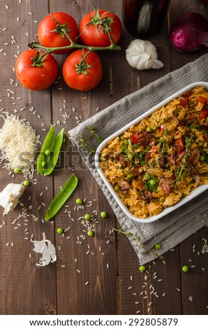 Cajun chicken with rice,  full of flavor and hot spices with fresh vegetable bio peas