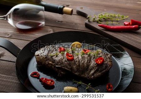 Beef steak with herbs and chilli, product photo with wine for client