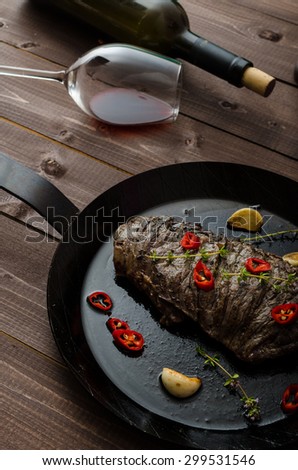 Beef steak with herbs and chilli, product photo with wine for client