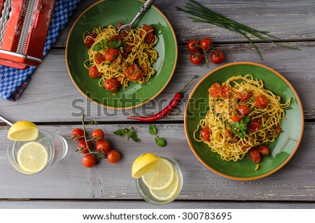Homemade semolina spaghetti with roasted cherry tomatoes and parmesan, fresh lemon limonade