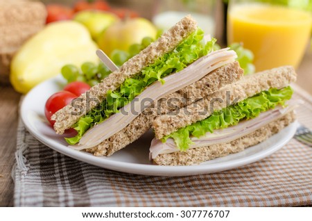 Back to school sandwich, simple sandwich whole grain bread, salad, ham and cheese. Milk and fresh juice, fruit for bio healthy