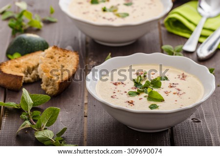 Creamy zucchini soup with chilli and oregano, crispy bread with garlic