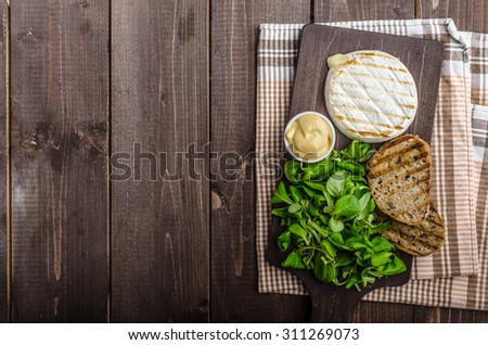 Grilled camembert with salad, panini toast and Dijon mustard
