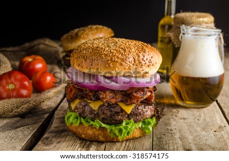American rustic bacon burger with cheddar, beef, salad and vegetable, old school picture, place for advertising