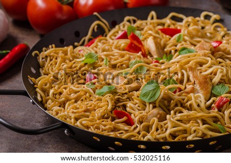 Chinese noodles chicken, hot peppers and garlic in