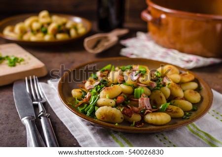 fried homemade gnocchi, lots of herbs and bacon in mixture, delicious food, fast and full of flavours