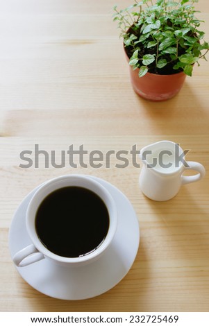 coffee and milk on wooden table, view from above.
