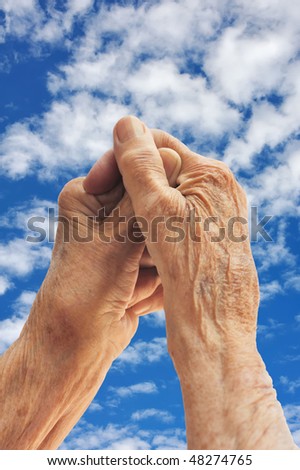 Senior woman\'s hands over sky