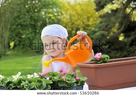 Young girl watering flowers