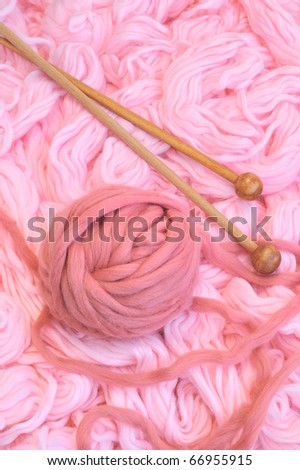 Sphere of pink wool with needles - still life