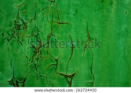 Peeling paint on wall - background texture. Pattern of rustic green grunge material. Green paint peeling off.