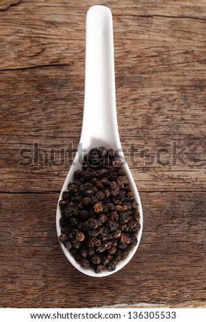 black peppercorn on the wooden background