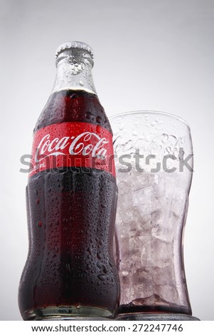 Kuala Lumpur, Malaysia 24th April 2015, low angle bottle of the coca cola and glass of ice on the white background