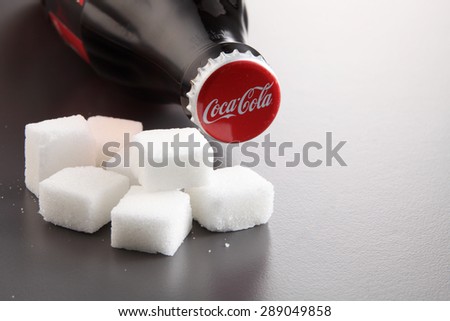 KUALA LUMPUR, MALAYSIA - june 6TH, 2015.coca cola bottle with raw cube sugar by the side