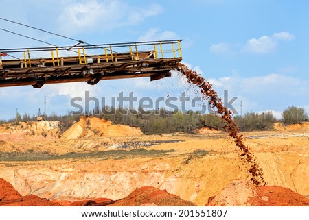 open mining pit with heavy machinery