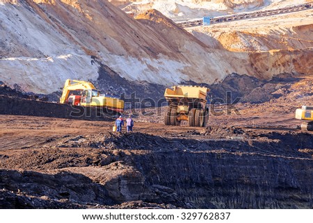 Open coal mining pit with heavy machinery