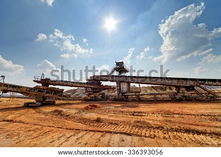 Open coal mining pit with heavy machinery