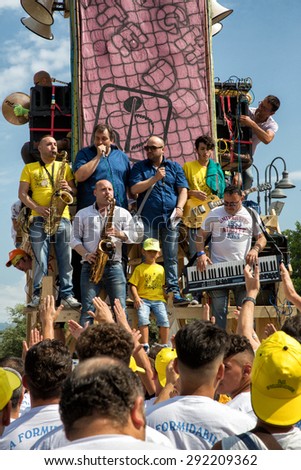 NOLA (NAPLES, ITALY) - JUNE 28: 8 wooden obelisks are carried on shoulders through all the towns streets by crowded teams of men that are called ??paranza?Â�.