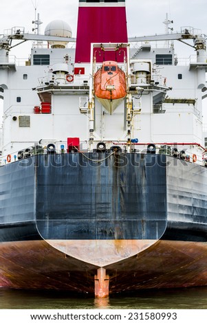Stern of a container ship with orange life raft