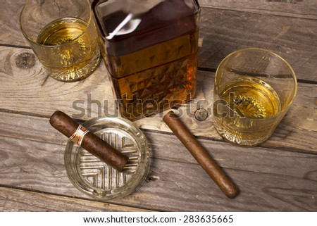Decanter of whiskey and a glass with cuban cigar