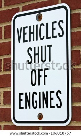 A white sign reading Vehicles Shut Off Engines