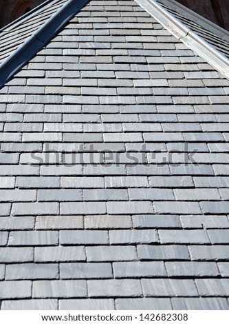 A rooftop covered with gray slate shingles