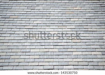 A rooftop covered with gray slate shingles