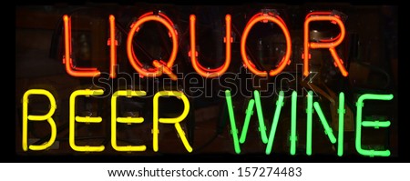 A multi colored neon sign reading Liquor Beer Wine