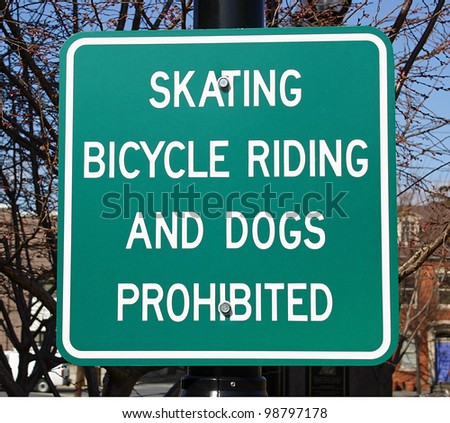 A street sign prohibiting skating, bikes and dogs