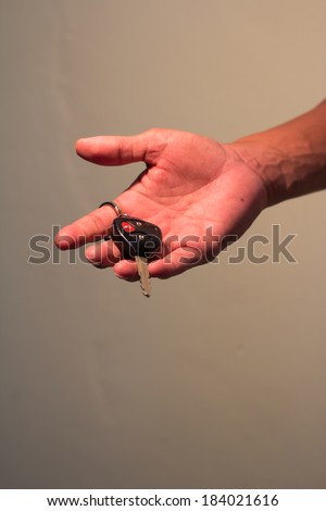 Man hand holds out key to the car Still life