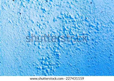 Dirty and swollen paint wall. blue background