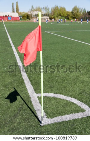 Red flag in corner of soccer field in summer day