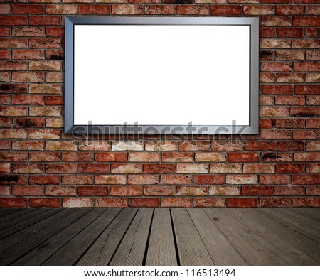 Blank billboard on brick wall in old interior. Place for advertisement.