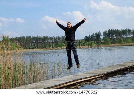 Man jumping on pier