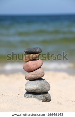 Six differently colored pebbles, stacked