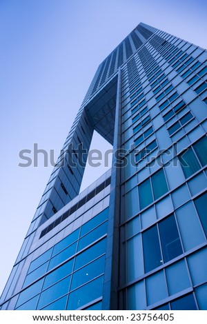 Modern futuristic office building over blue sky