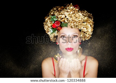 Young female model wearing a Christmas hat; Heart earrings; Gold dust;