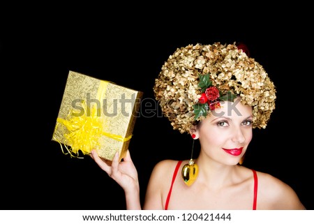 Young female model wearing a Christmas hat; Heart earrings;Gift box;