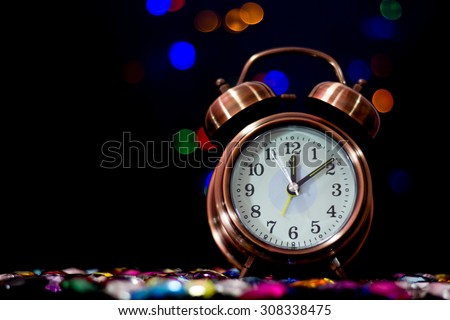 bokeh background with  alarm clock and black border at midnight