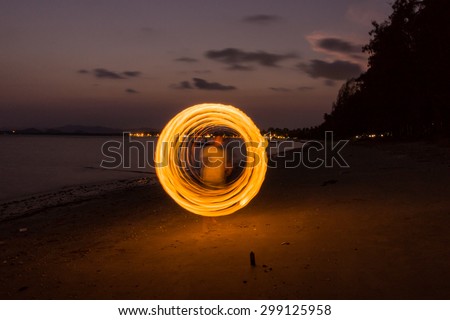 Swinging a Steel wool fire on the beach at night