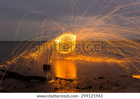 Swinging a Steel wool fire on the beach