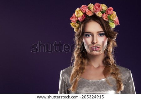 Beautiful young girl with a floral ornament in her hair