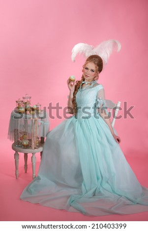 Princess on pink background with beautiful pastries