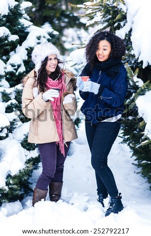 Two joyful and energetic friends playing games and having fun, having a snow ball fight in the snow mountains landscape during a skiing holiday on a sunny winter day, outdoors. snowballs