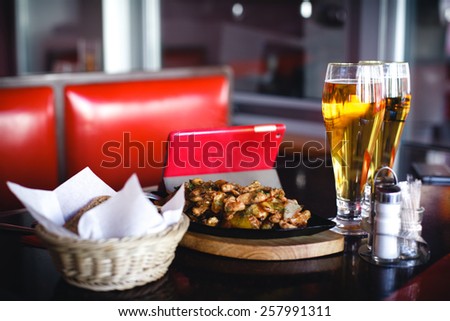 beer with chicken at the bar. order food at the bar waiting for the client.