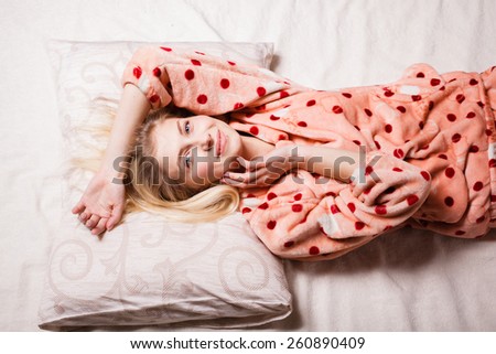 morning beautiful girl woke up in bed smiling happy. beautiful blonde woke up in bed, stretching